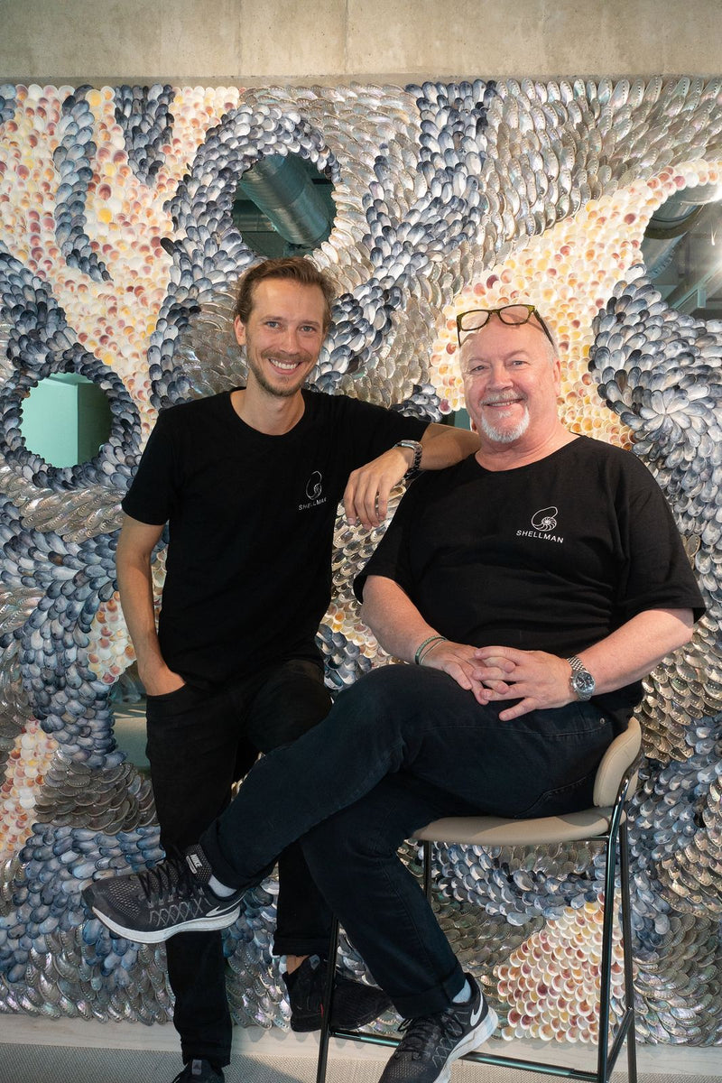 Buster Eriksson and Mikael Hjärtsjö sitting in front of the finished shell wall of The Flow