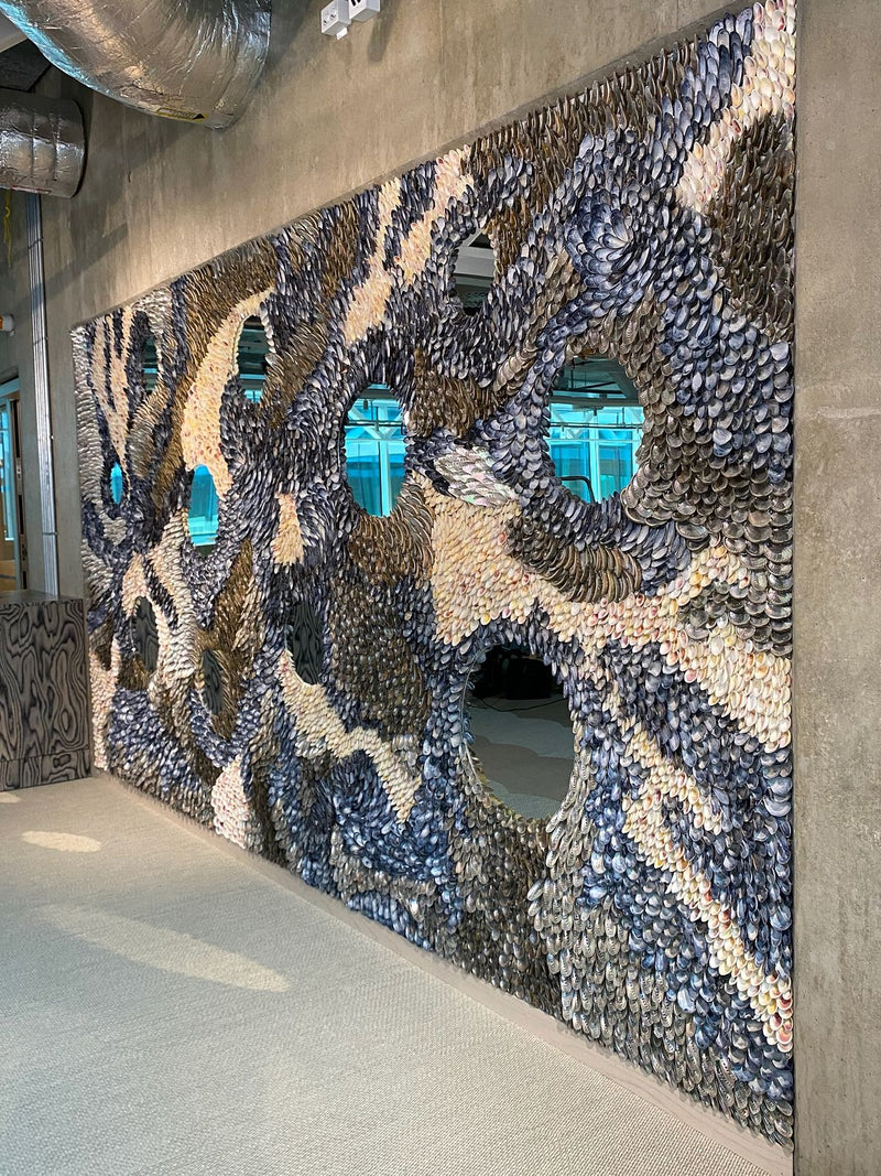 The Flow seen from the side along the concrete wall, shell bands flowing around round mirrors